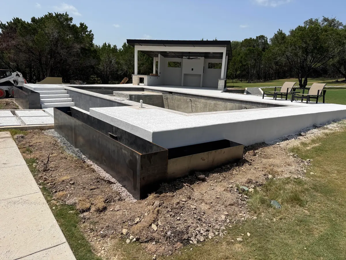 Steel planters wrapping a new pool deck, during construction