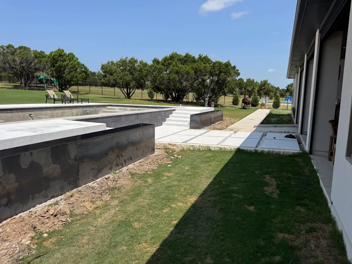 Steel planters along the pool deck and walkway, during construction